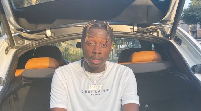 RISING RAP STAR: J BERT RELEASES 3 ALBUMS OVER THE YEARS A person sitting in a car Description automatically generated